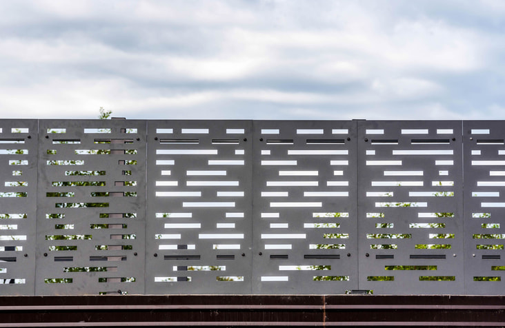 Hekwerk met panelen van geperforeerd metaal